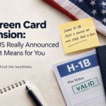 H-1B green card suspension: US flag, visa documents and a green card on an office desk